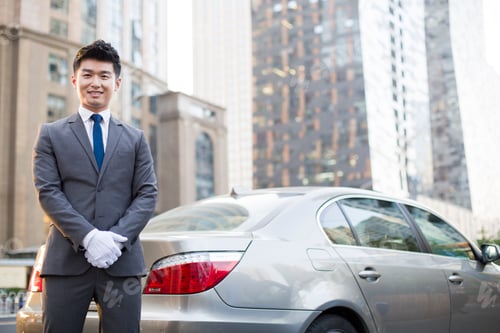 Preview: Portrait of chauffeur standing next to the car