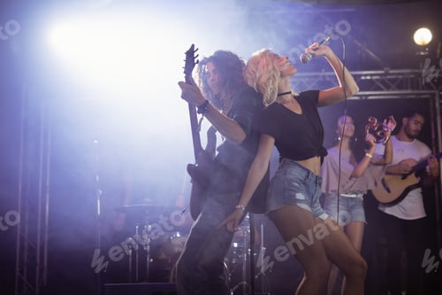 Preview: Young female singer with male guitarist performing at nightclub