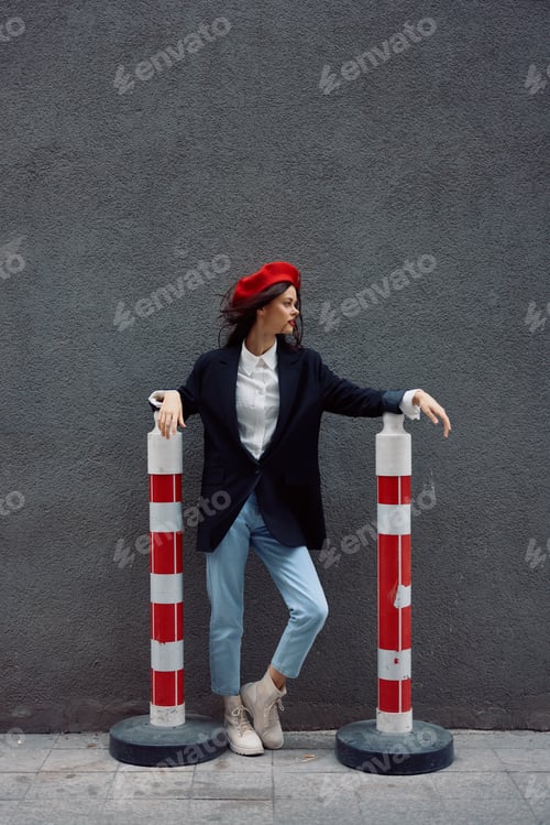 Preview: Fashion woman standing on the street in front of the city and road works tourist in stylish clothes