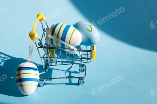 Preview: Easter eggs in the shopping cart on a blue background