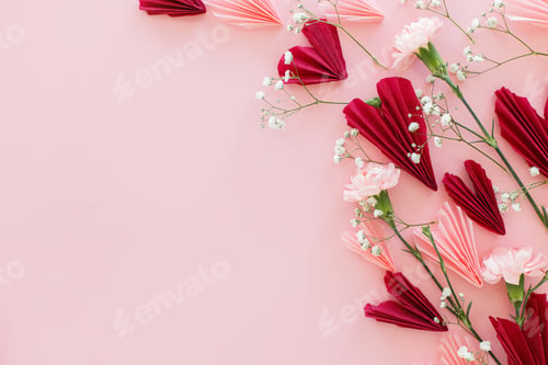 Preview: Valentines day flat lay. Stylish pink and red hearts composition with flowers on pink background