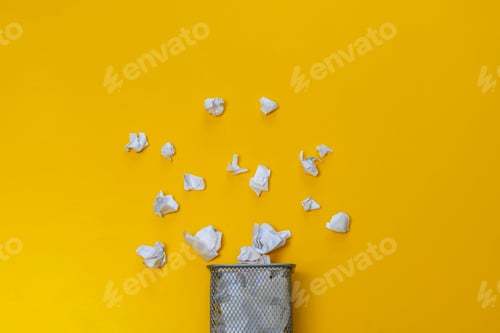 Preview: bunch of crumpled paper balls in the metal rubish bin urn basket on the colorful background