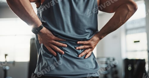 Preview: Man, hands and back injury with pain at gym for muscle tension, workout accident or sprain. Closeup