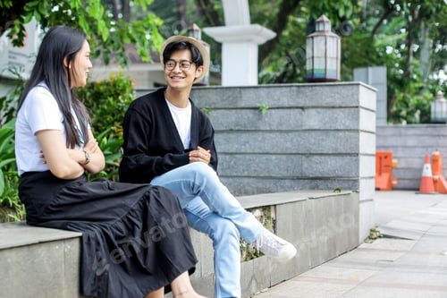 Preview: Couple Sitting On Sidewalk