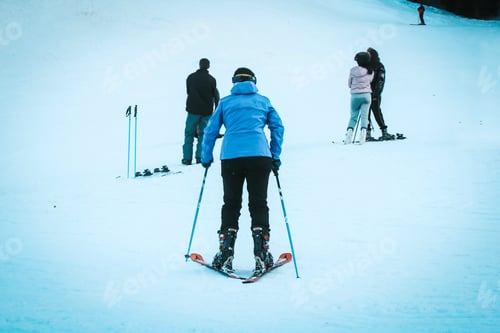 Preview: Woman from behind skiing in the mountain