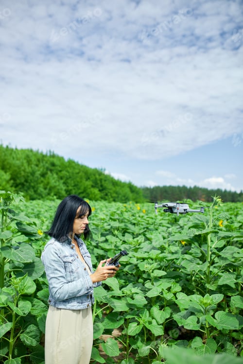 Preview: Young woman learning how to pilot her drone in, female using, piloting, fly drone