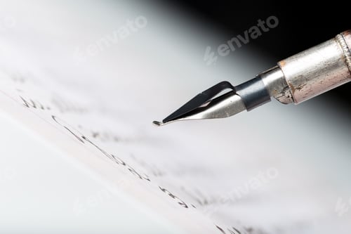Preview: Close-up view of a fountain pen writing on paper in a well-lit area during the day