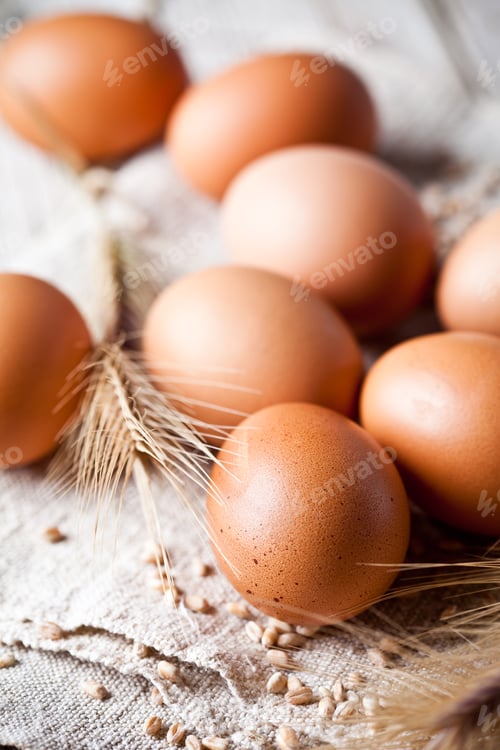 Preview: fresh brown eggs, wheat seeds and ears