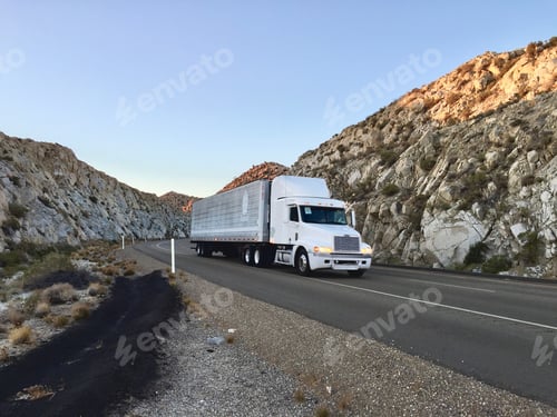 Preview: Big rig on the road through the desert pass in California
