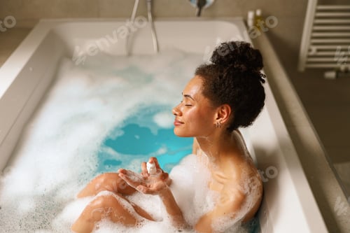Preview: A young woman is happily bathing in a bathtub