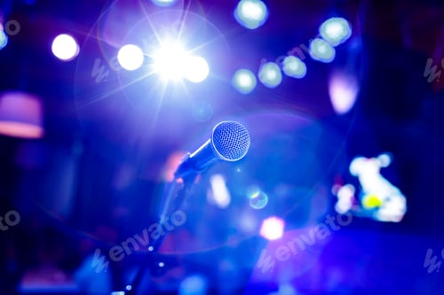 Preview: Microphone on stage against a background of auditorium.