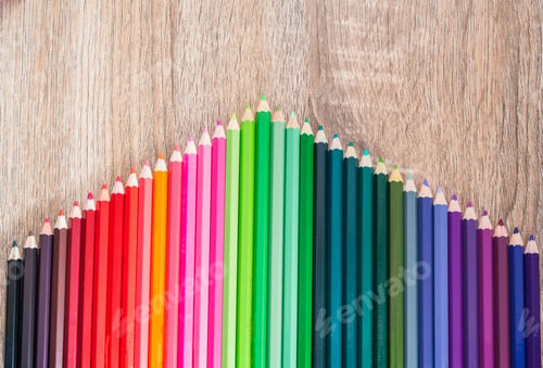 Preview: Multi Color pencils in scale with rainbow style isolated on wooden background