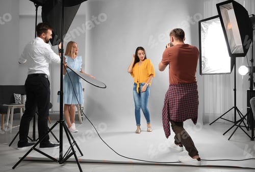 Preview: Professional team working with model in photo studio