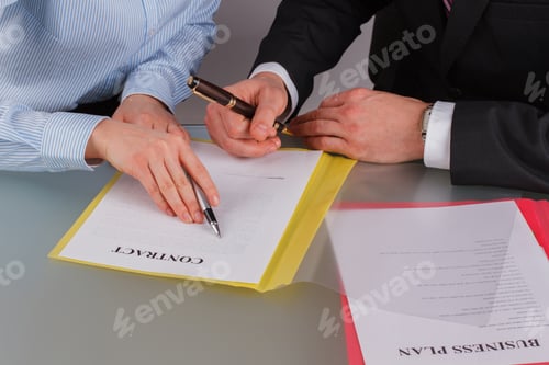 Preview: Close up business people discussing business contract at meeting.