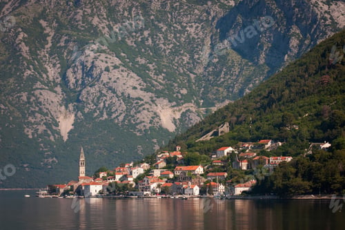Preview: View across a lake towards a village on the slopes of a mountain in Montenegro.