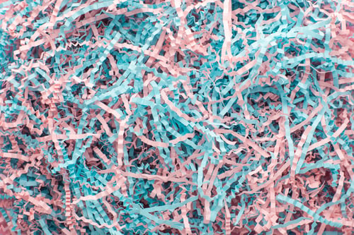 Preview: Texture of shredded pink and blue paper for gifting and shipping.