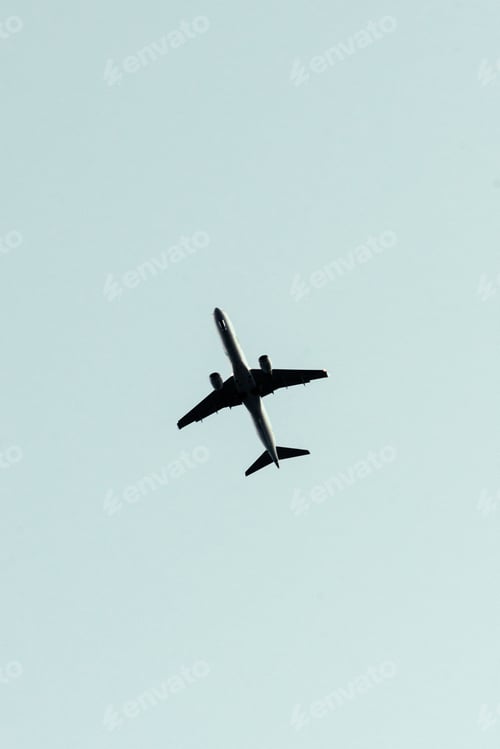 Preview: Beautiful vertical view of an airplane flying in a clear sky