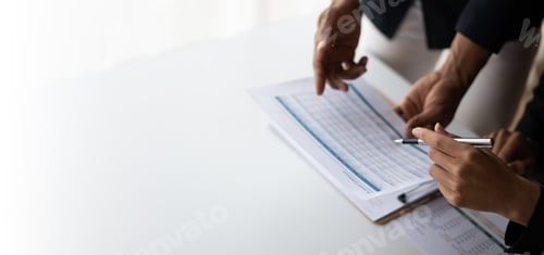 Preview: Group of confident business people point to graphs and charts to analyze market data, balance sheet,