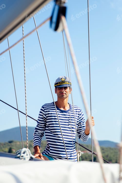 Preview: Handsome young man on a sailboat