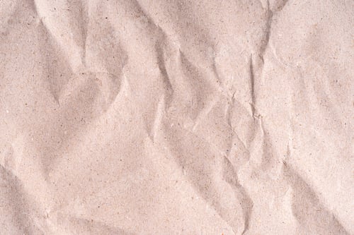 Preview: Old wrinkled brown craft paper poster texture. Blank creased crumpled grainy beige kraft paper