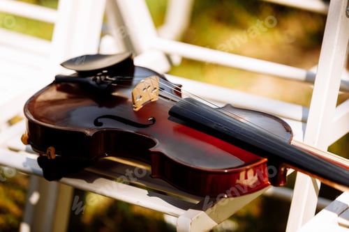 Preview: Beautiful violin on a white chair. selective focus.