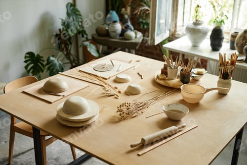Preview: Wooden table in cozy pottery studio setup for ceramics workshop