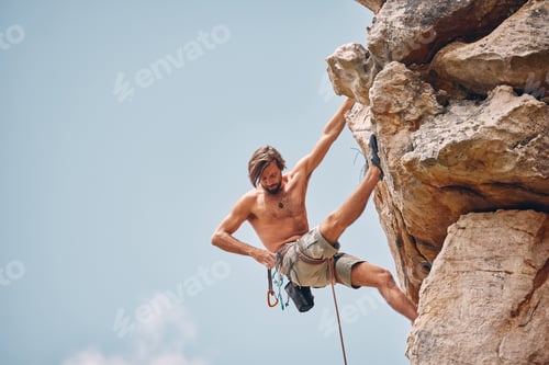Preview: Mountain or rock climbing, cliff hanging and adrenaline junkie out on adventure and checking his sa