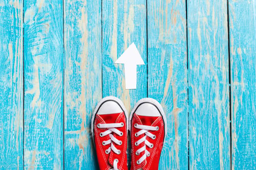 Preview: red sneakers on wooden background.