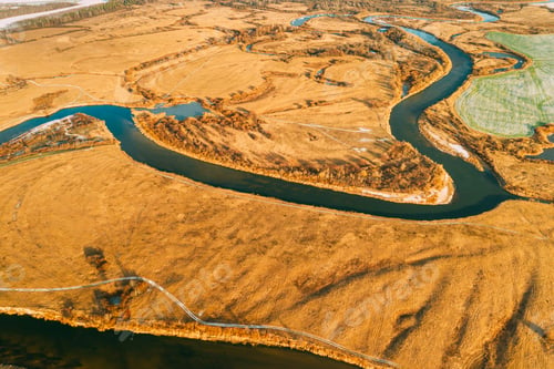Preview: Aerial View Of Dry Grass And Partly Frozen River Landscape In Late Autumn Day. High Attitude View