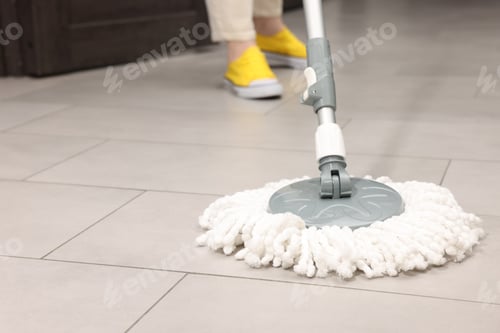 Preview: Woman cleaning floor with string mop indoors, closeup
