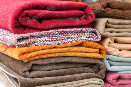 Preview: Pile of folded colorful textile. Heap of cloth fabric