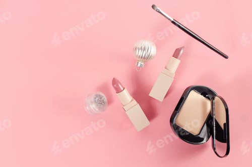 Preview: set with makeup products and Christmas decor on pink background.