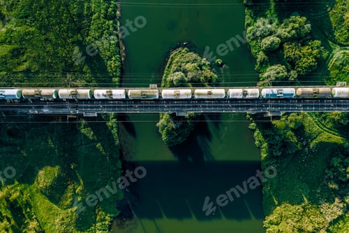 Preview: Aerial view of Railway railroad tracks and cargo train over the river