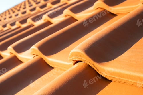 Preview: Overlapping rows of yellow ceramic roofing tiles covering residential building roof