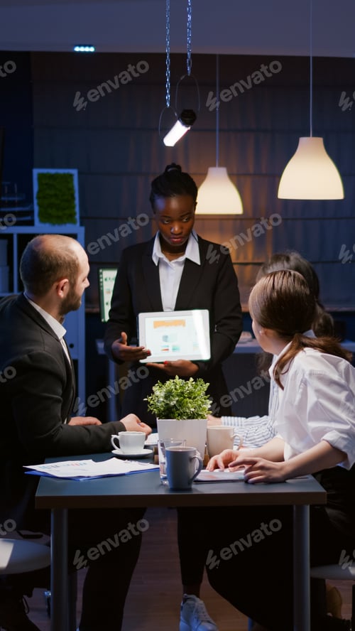 Preview: Overworked workaholic businesswoman with dark skin explaining management graphs