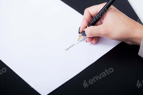 Preview: Close up girl hand putting signature on document. She situating at desk. Business concept. Low angle