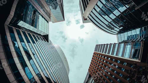 Preview: Low angle shot of modern buildings under the grey sky