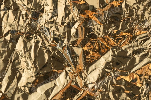 Preview: Golden crumpled shiny metallic paper. Yellow tinfoil texture for holiday. Glossy crinkled kitchen