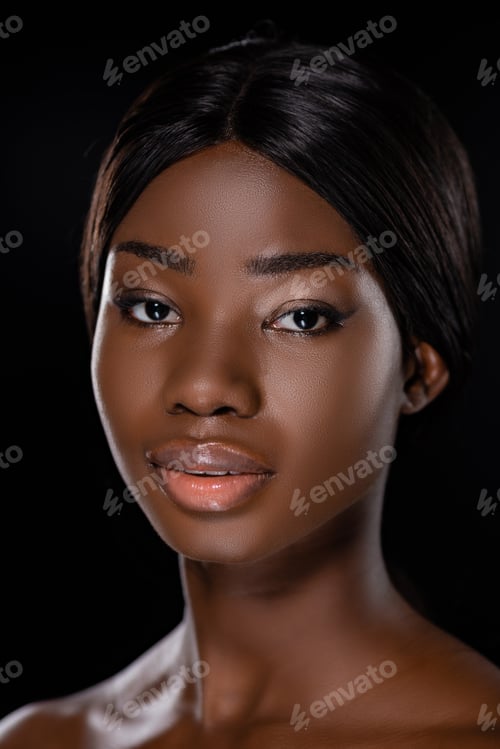 Preview: portrait of african american naked woman looking at camera isolated on black