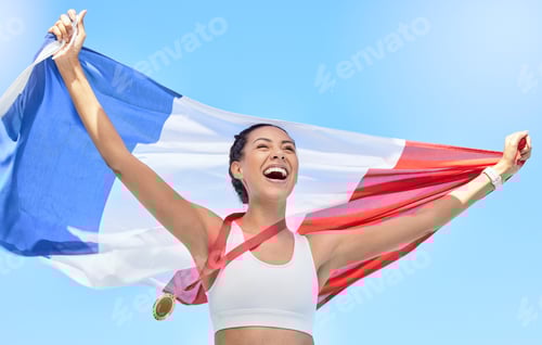 Smiling Woman Holding Flag with Medal Against Sky