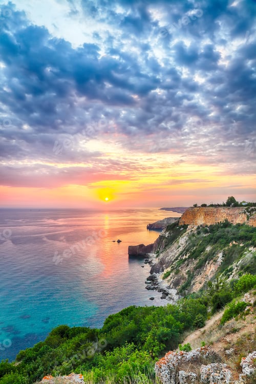 Preview: Unbelivable sunset at cape Fiolent with bushes grass and rocks at foreground.