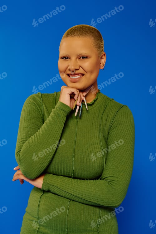 Preview: A fashionable young woman exudes confidence with a vibrant smile, dressed in green
