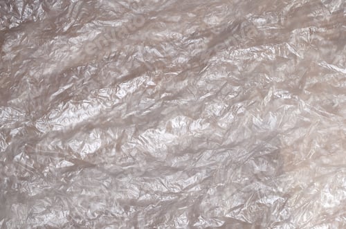 Preview: Texture of white crumpled cellophane surface transparent on sunlight.