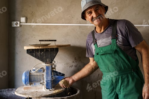 Preview: Men hands with a handful of oats on the background