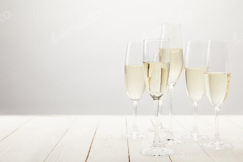 Preview: closeup shot of champagne glasses on white wooden table