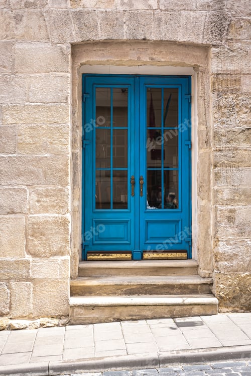 Preview: Facade of an old building with blue doors.