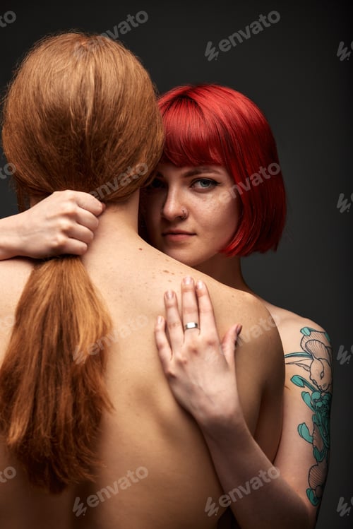 Preview: Sexy passionate couple in love in the studio. The woman's arms embrace a handsome half-naked man
