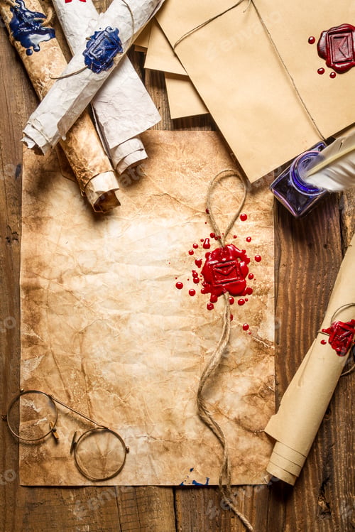 Preview: Closeup of old scrolls and sealing wax on wooden table