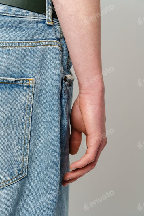 Preview: Close-Up of a Person With Arm Alongside a Denim Blue Jeans Pocket