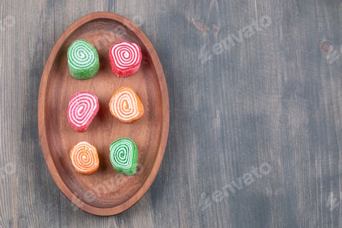 Preview: Colorful marmalade candies on wooden plate